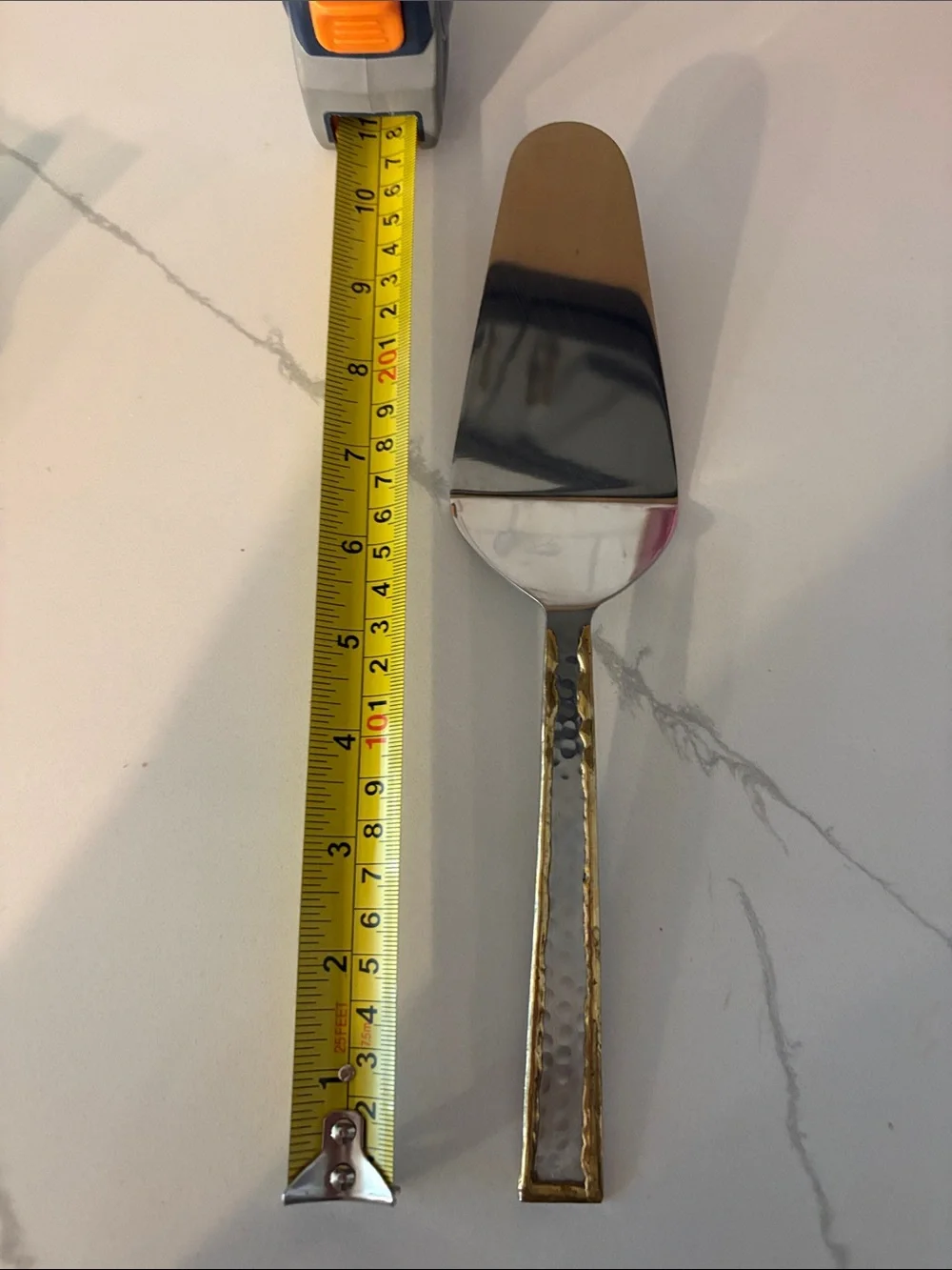 Silver cake server with hammered accents and gold trim